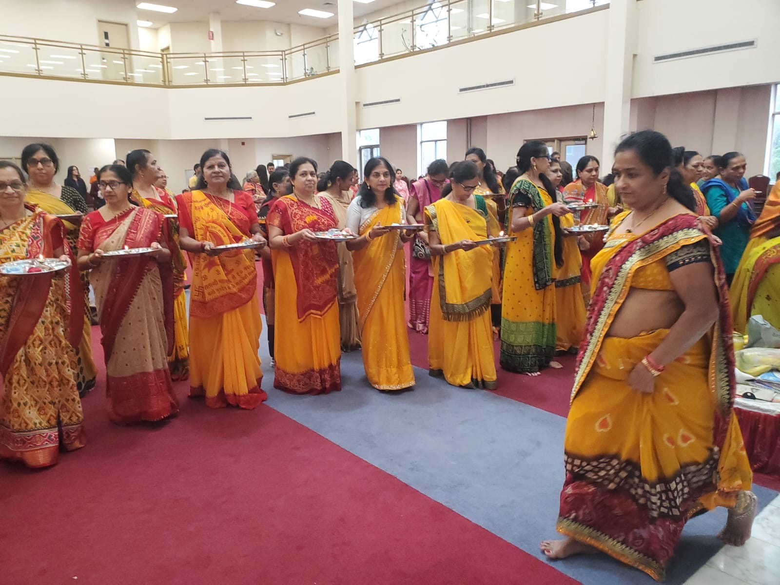 Women in procession with aarti thalis