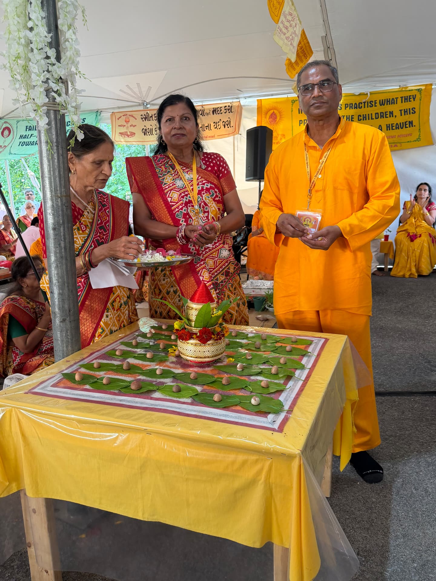 Devotees offering flowers at the decorated kalash sthapana table