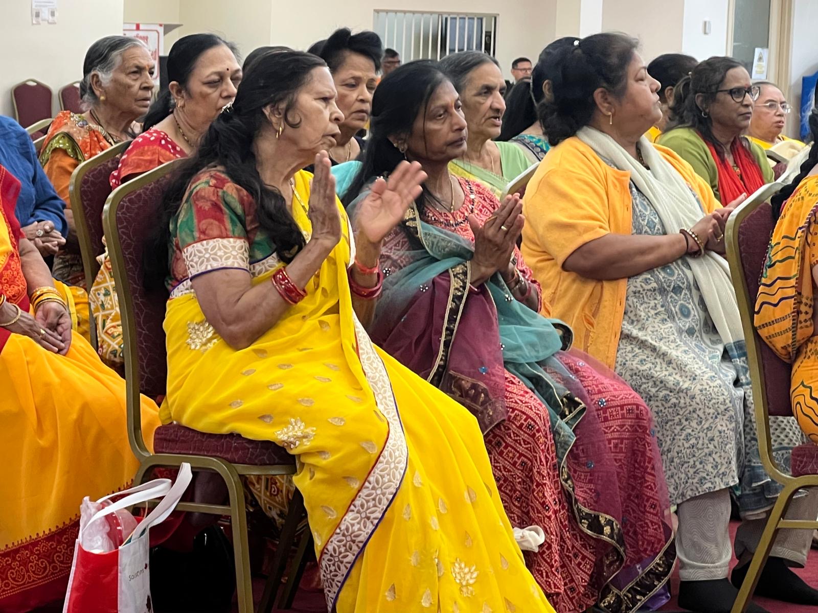 Devotees with folded hands during prayers